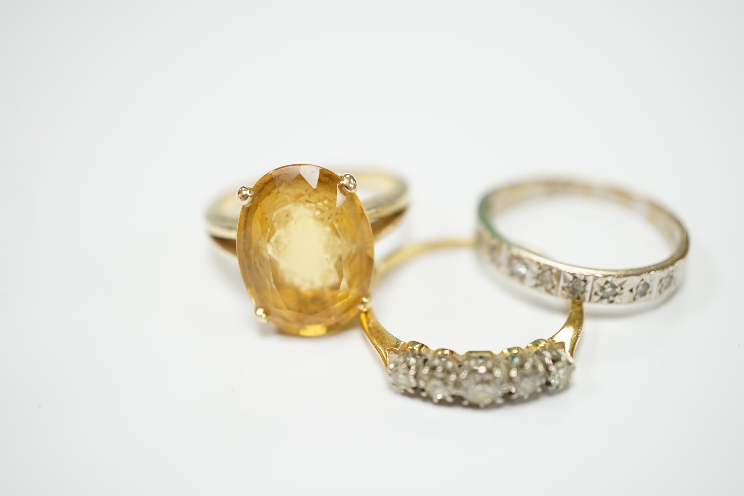 An 18ct and graduated five stone diamond set half hoop ring, size P/Q, one other 18ct and diamond chip set half hoop ring, gross weight 4.8 grams and a 14k and citrine set dress ring, gross weight 5.4 grams.